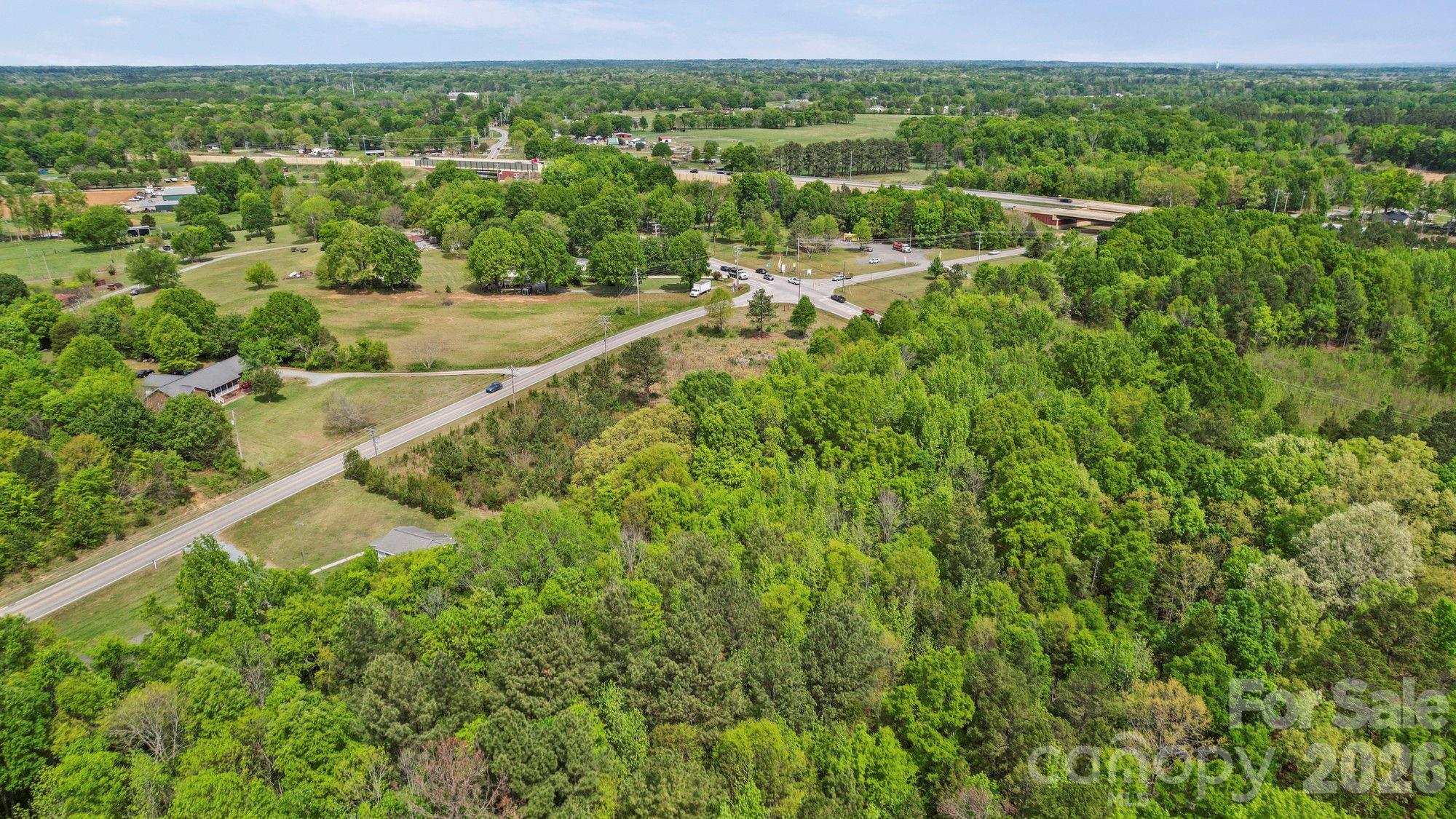 0 Faith Church Road Indian Trail, NC 28079 - Photo 14 of 21 a view of a green field with lots of bushes