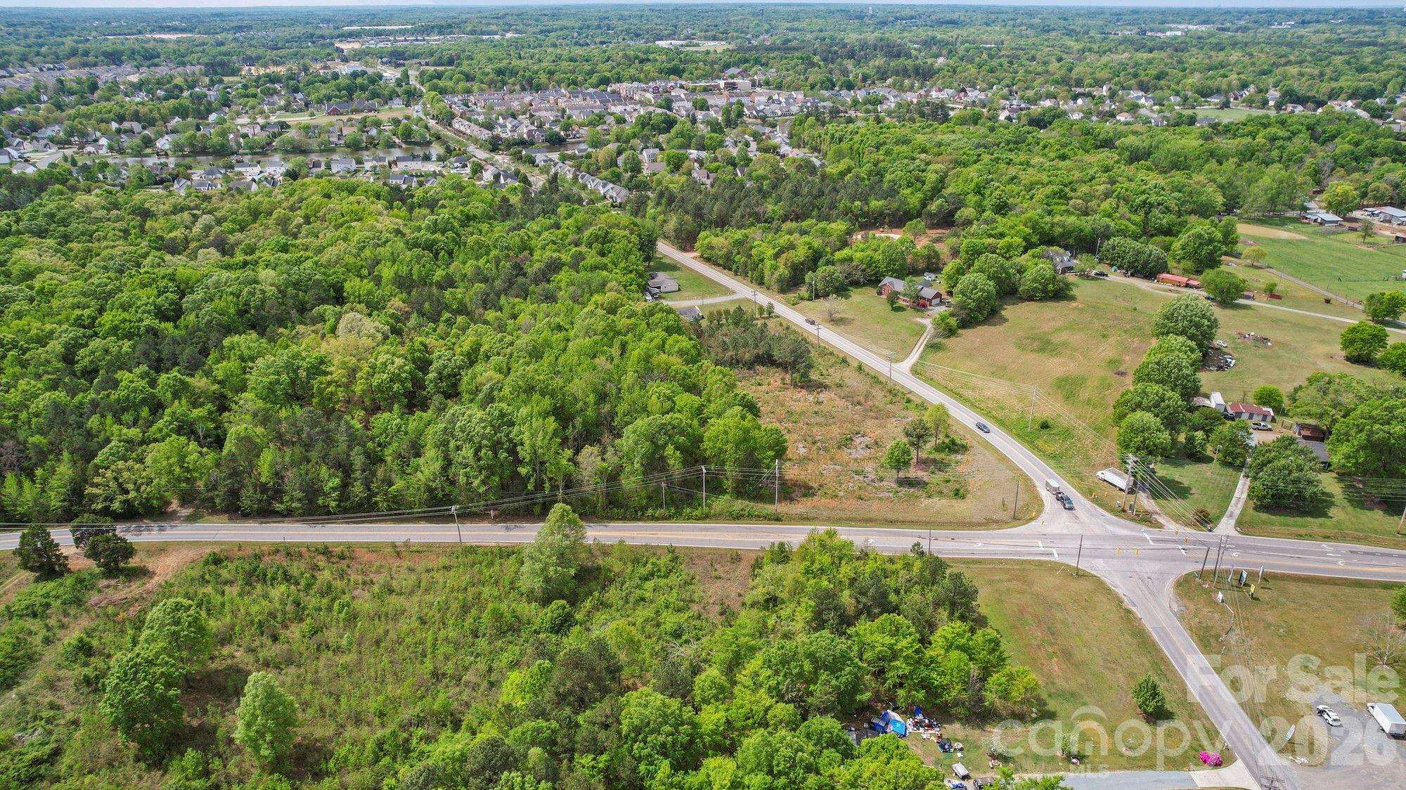 0 Faith Church Road Indian Trail, NC 28079 - Photo 9 of 21 an aerial view of residential houses with outdoor space and trees