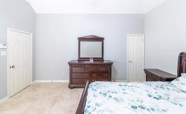 a bedroom with a bed and a mirror