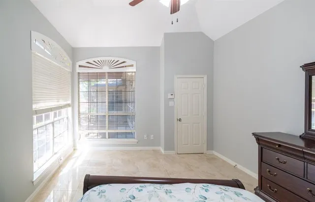 a view of a bedroom with furniture and windows