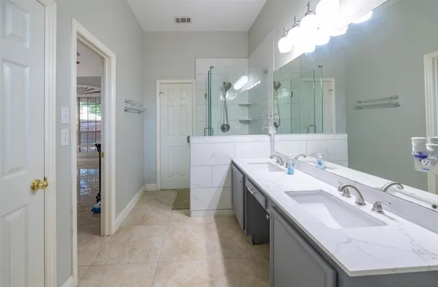 a bathroom with a sink double vanity and a mirror