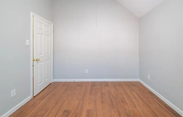 a view of a room with wooden floor