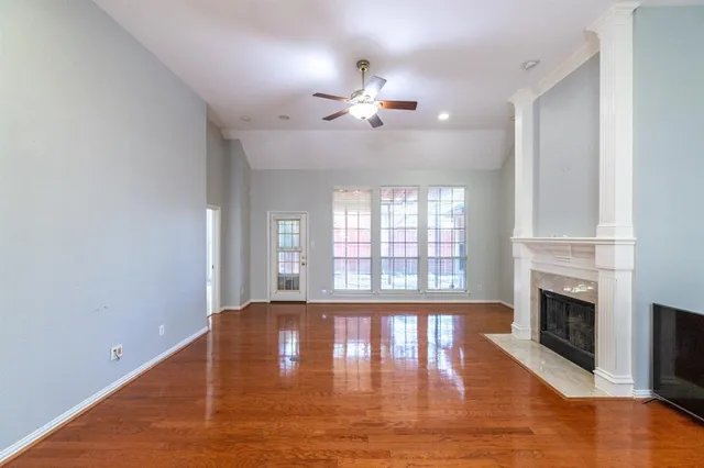 a view of an empty room with window and fireplace