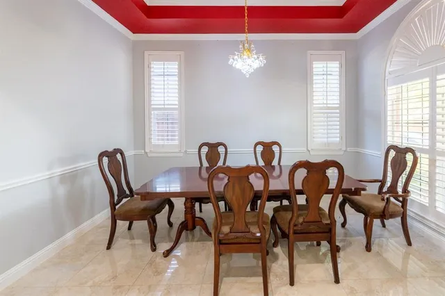 a view of a dining room with furniture and chandelier