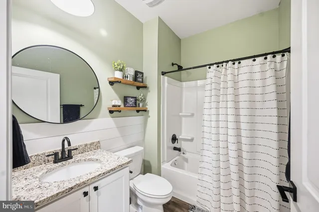 a bedroom with furniture and a flat screen tv