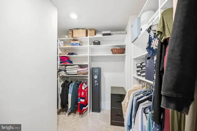 a bedroom with a bed and a dresser in it