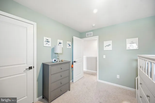 a bedroom with a bed and a lamp