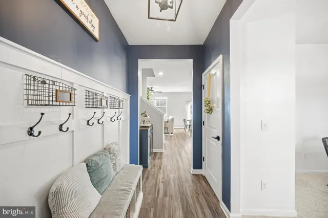 a dining room with furniture a chandelier and wooden floor