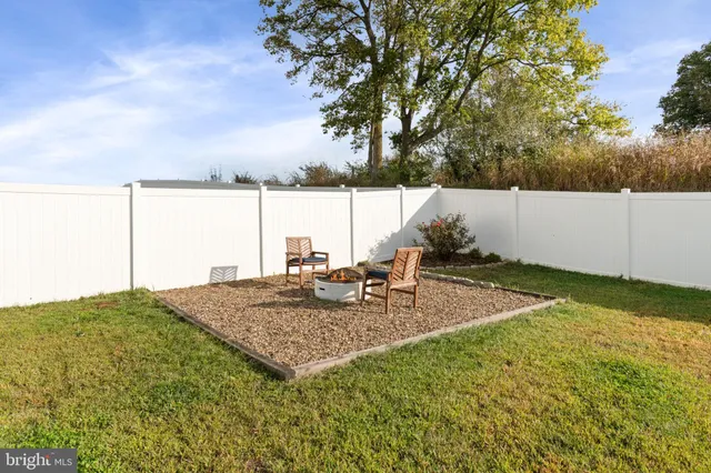 an aerial view of a house with garden space and street view