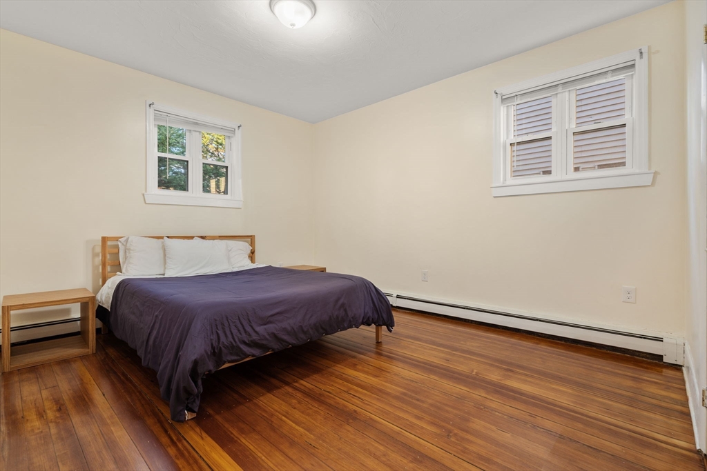 19 Carmen Street, Unit 2 Boston, MA 02121 - Photo 11 of 18 a bedroom with a bed and wooden floor