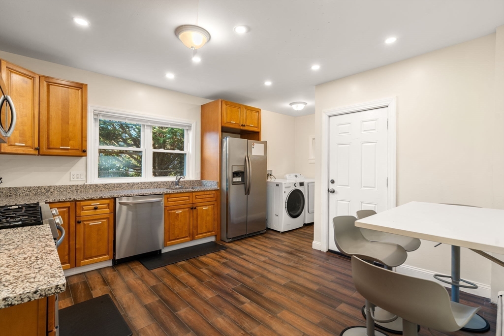 19 Carmen Street, Unit 2 Boston, MA 02121 - Photo 5 of 18 a kitchen with a sink a refrigerator and wooden cabinets