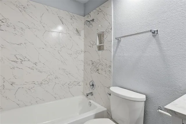 a bathroom with a bathtub and a toilet