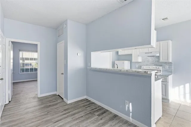 a bathroom with granite countertop a sink and a mirror