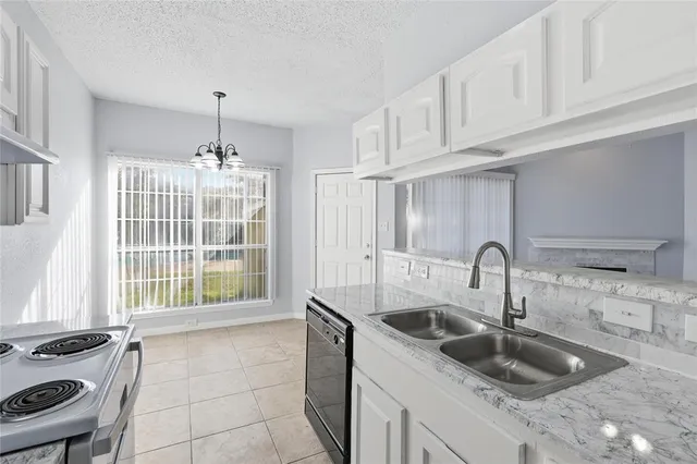 a kitchen with a sink and a stove top oven