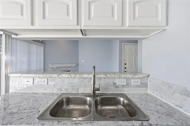 a kitchen with a sink and cabinets
