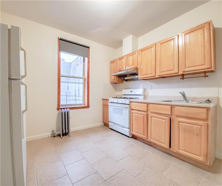 1919 Bay Ridge Parkway Brooklyn, NY 11204 - Photo 2 of 6 a kitchen with stainless steel appliances granite countertop a stove a sink and a refrigerator