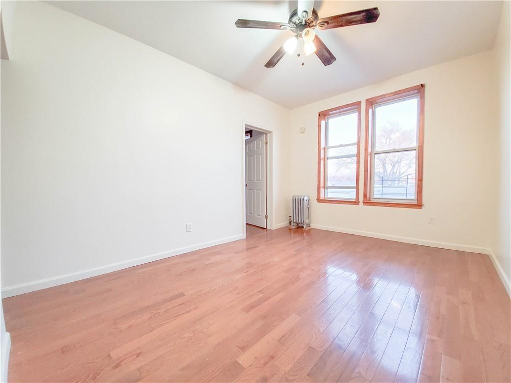 1919 Bay Ridge Parkway Brooklyn, NY 11204 - Photo 3 of 6 an empty room with wooden floor fan and windows