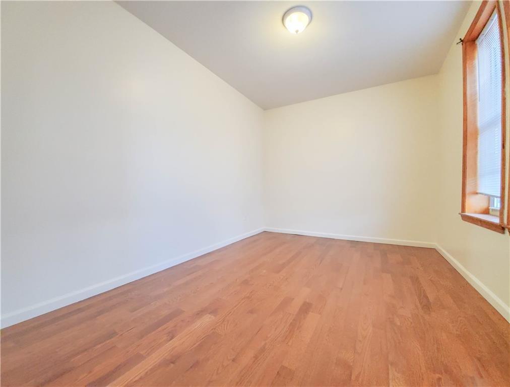 1919 Bay Ridge Parkway Brooklyn, NY 11204 - Photo 4 of 6 a view of empty room with wooden floor and fan