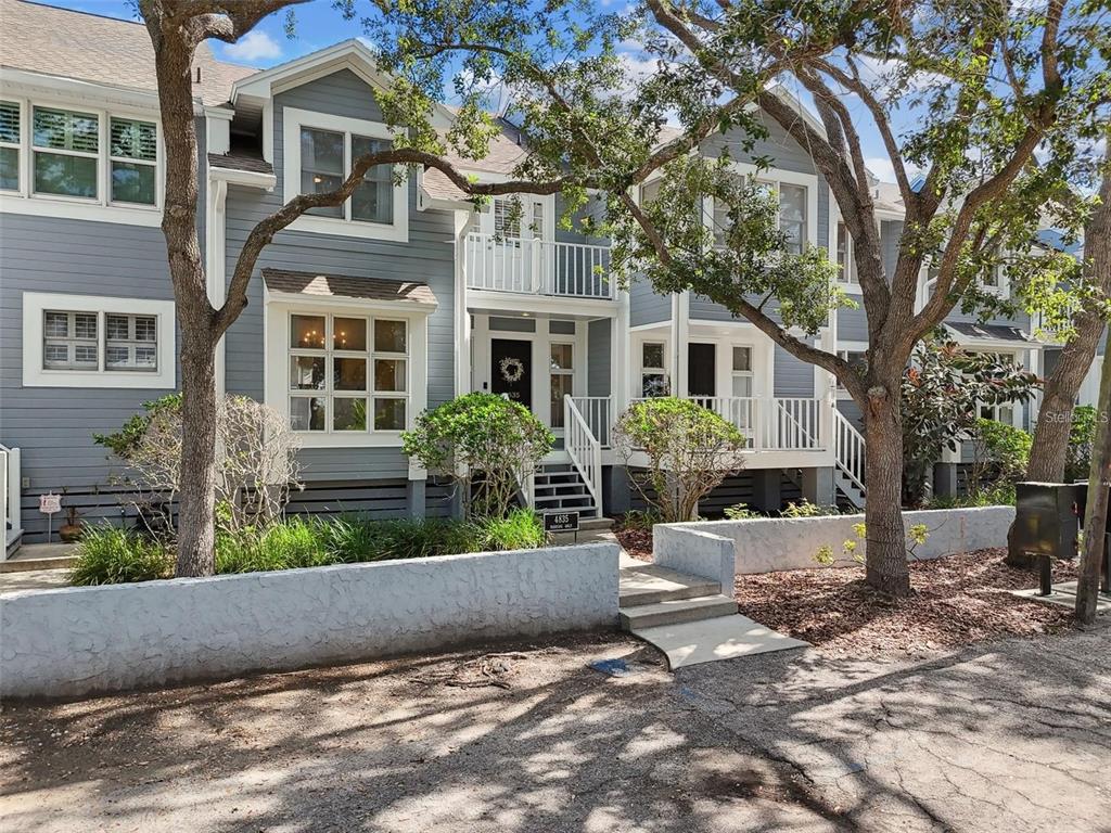 4835 West Flamingo Road Tampa, FL 33611 - Photo 1 of 51 a front view of a house with a yard and potted plants