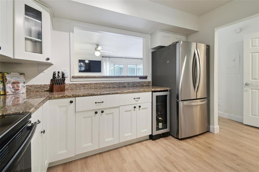 4835 West Flamingo Road Tampa, FL 33611 - Photo 11 of 51 a kitchen with stainless steel appliances granite countertop a refrigerator and a stove