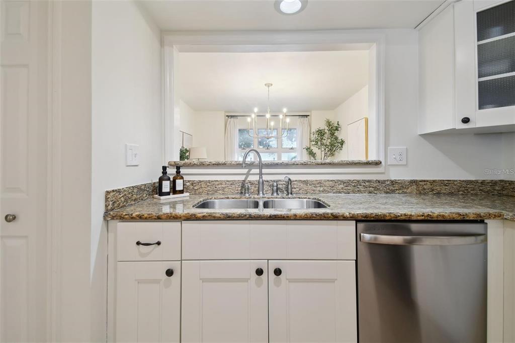 4835 West Flamingo Road Tampa, FL 33611 - Photo 13 of 51 a kitchen with a sink and cabinets