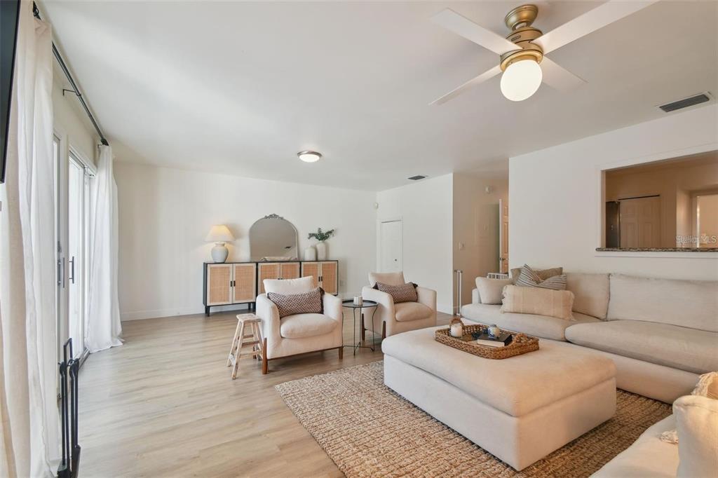 4835 West Flamingo Road Tampa, FL 33611 - Photo 18 of 51 a living room with furniture and a chandelier