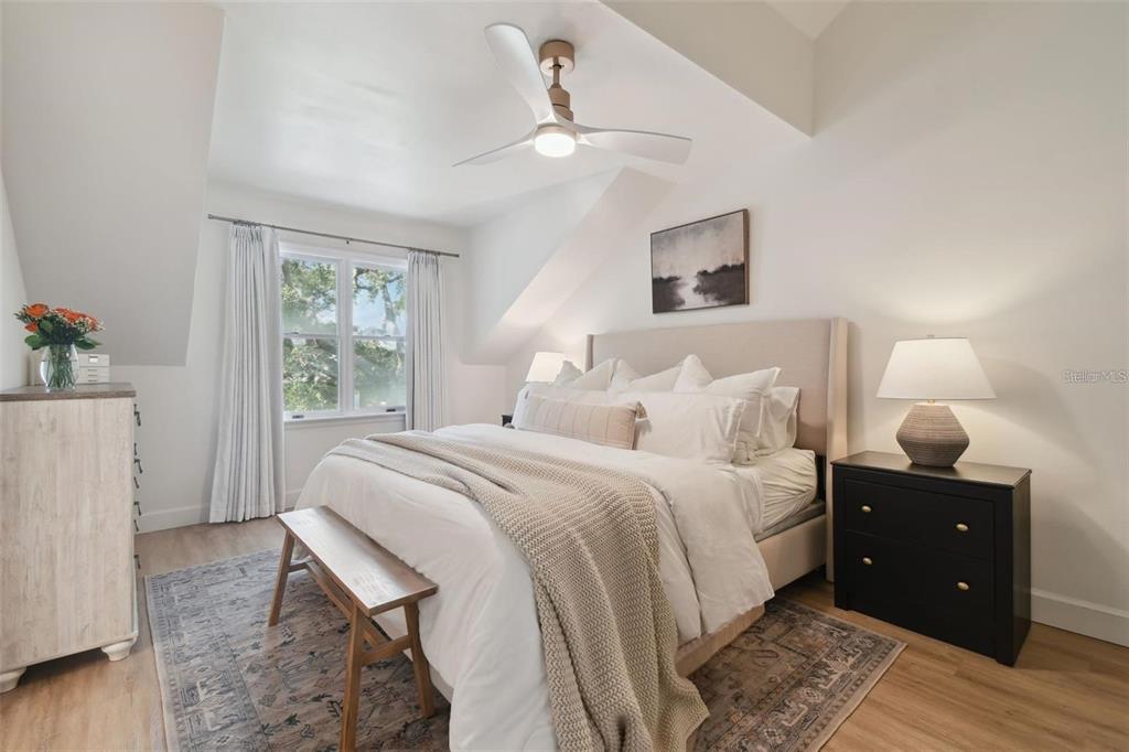 4835 West Flamingo Road Tampa, FL 33611 - Photo 22 of 51 a bedroom with a bed and wooden floor