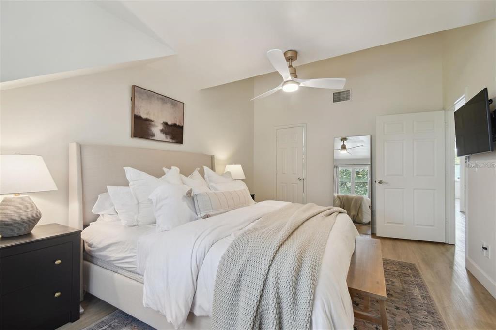 4835 West Flamingo Road Tampa, FL 33611 - Photo 23 of 51 a bedroom with a bed and a flat tv screen on dresser