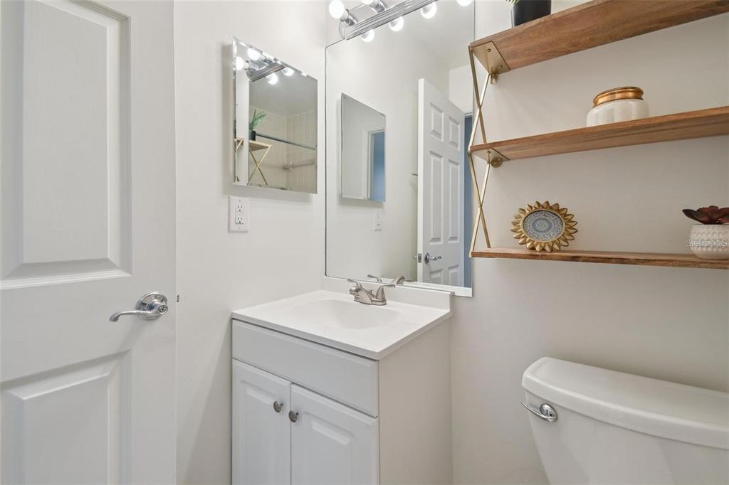 4835 West Flamingo Road Tampa, FL 33611 - Photo 33 of 51 a bathroom with a sink a toilet and mirror