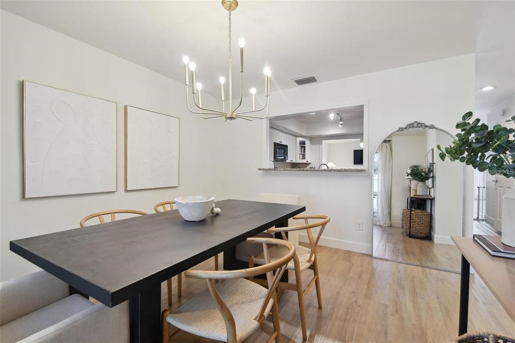 4835 West Flamingo Road Tampa, FL 33611 - Photo 7 of 51 a view of a dining room with furniture and wooden floor