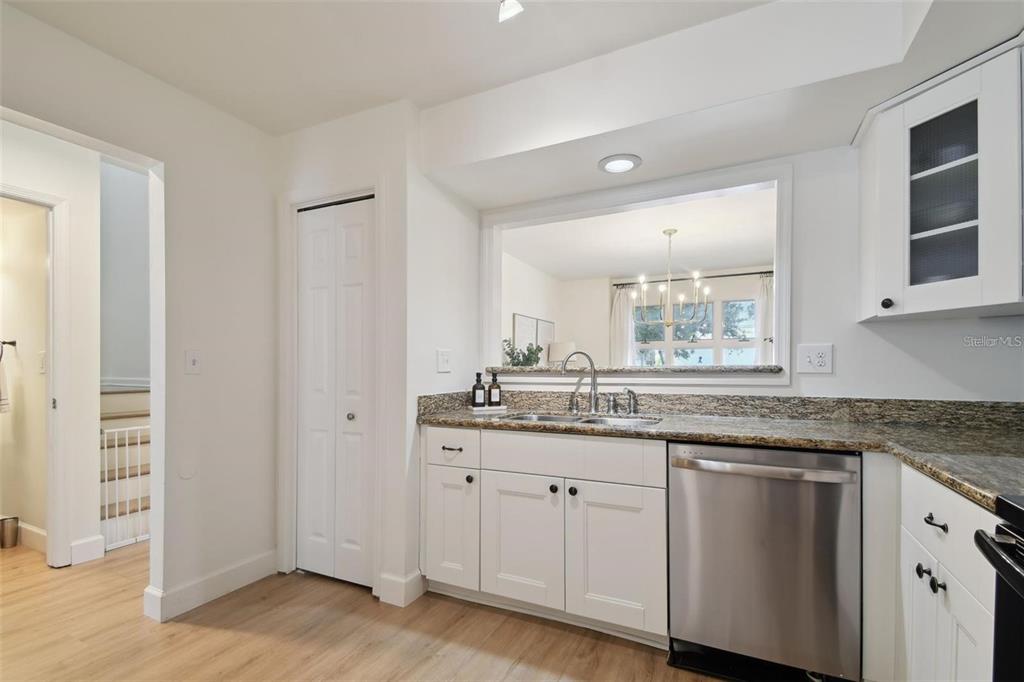 4835 West Flamingo Road Tampa, FL 33611 - Photo 10 of 51 a kitchen with white cabinets and sink