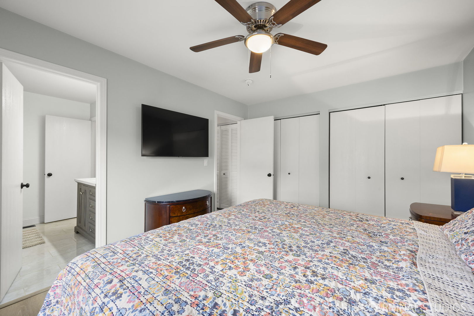 2828 Bluewater Circle Naperville, IL 60564 - Photo 12 of 17 a bedroom with a bed and a flat tv screen on dresser