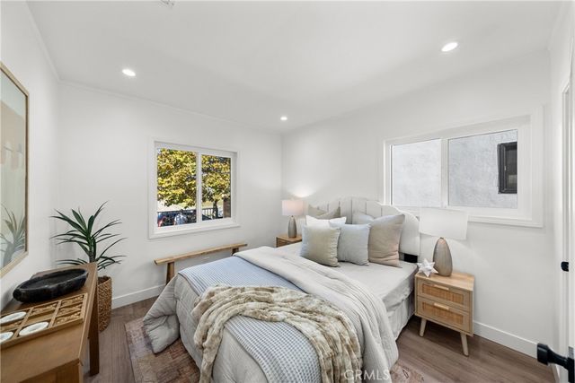 a bedroom with a bed and a potted plant