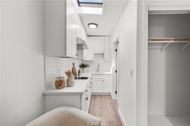 a view of a kitchen with sink and cabinets
