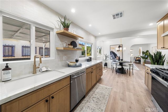 a kitchen with counter top space a sink appliances and cabinets