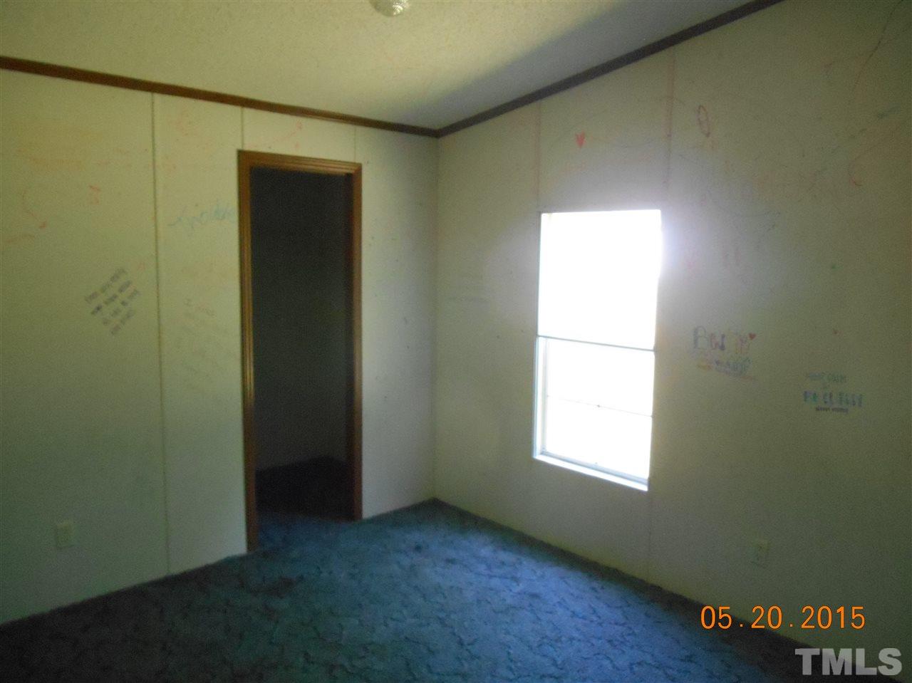 8714 South Creek Road Willow Spring, NC 27592 - Photo 8 of 9 an empty room with windows