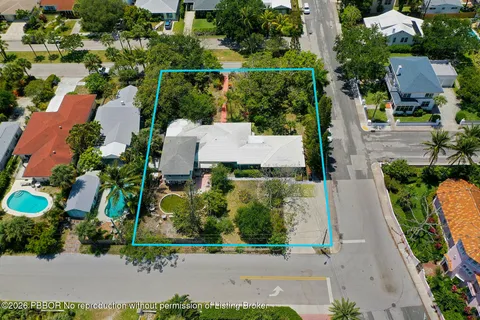 an aerial view of a house with a yard and garden