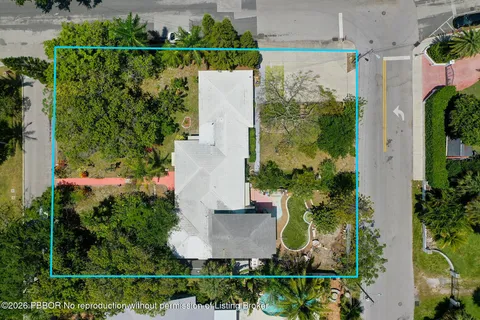 an aerial view of a house with a yard and garden