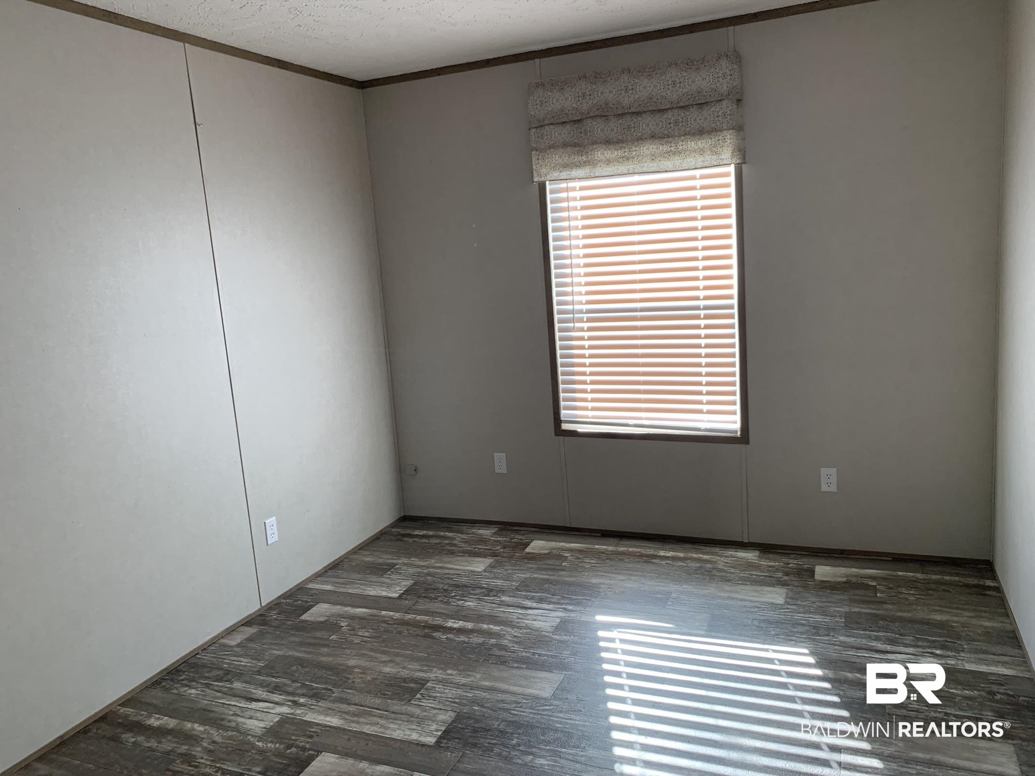 16876 County Road 87 Elberta, AL 36530 - Photo 10 of 13 Empty room featuring a textured ceiling and ornamental molding