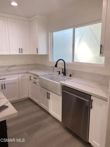 a kitchen with a sink cabinets and appliances