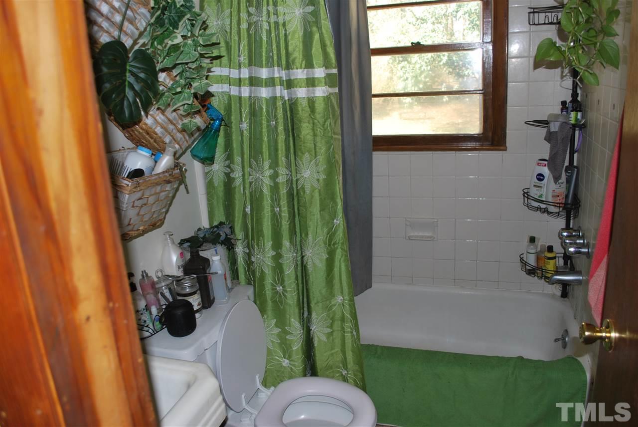 111 Weston Road Garner, NC 27529 - Photo 6 of 10 a bathroom with a sink toilet and window