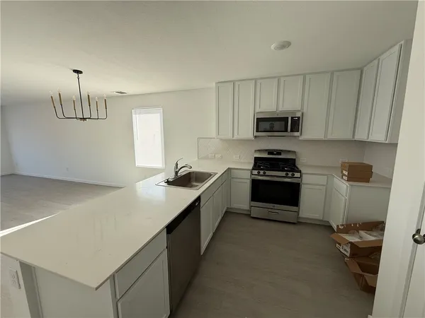 a kitchen with a sink and a stove top oven