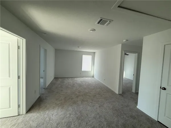 a view of an empty room and a window