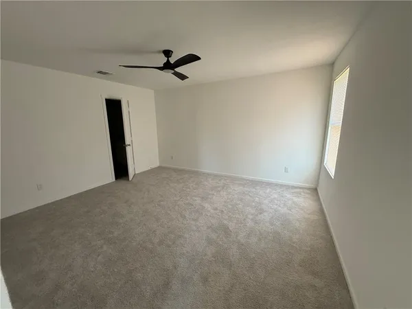 a view of a big room with a ceiling fan