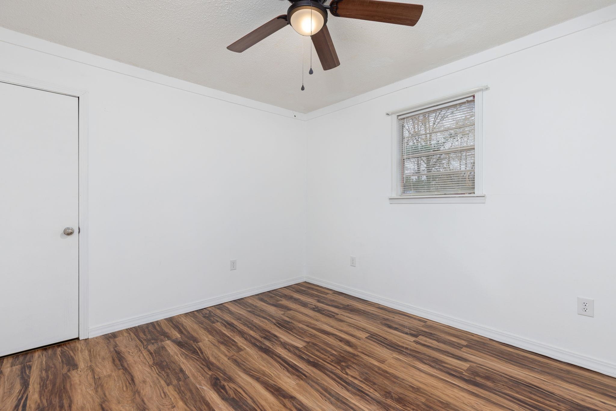 104 Huddleston Drive Ripley, MS 38663 - Photo 15 of 26 Unfurnished room with ceiling fan, dark hardwood / wood-style flooring, and a textured ceiling