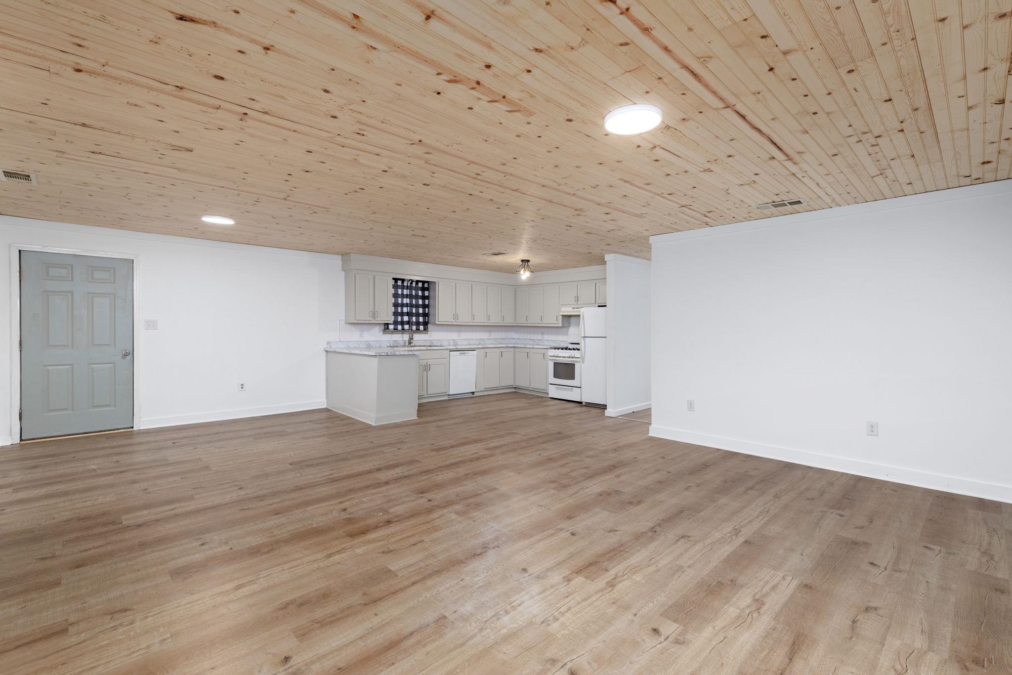 104 Huddleston Drive Ripley, MS 38663 - Photo 5 of 26 Unfurnished living room with light wood-type flooring and wood ceiling