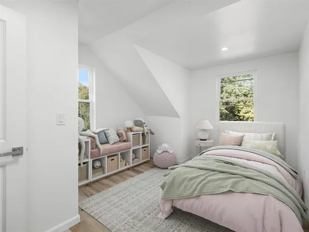 a bedroom with a bed and a wooden floor