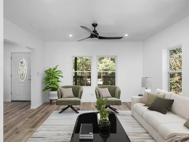 a living room with furniture and a large window