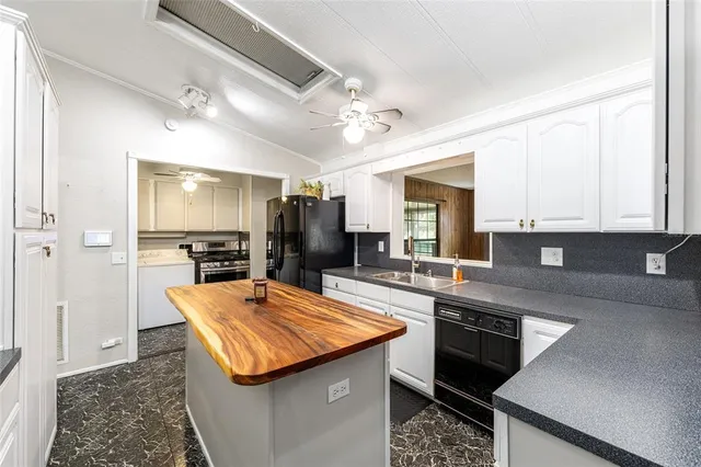 a kitchen with stainless steel appliances granite countertop sink stove and refrigerator