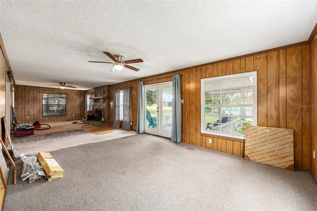 a view of a house with a big yard and potted plants